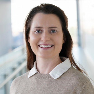 Woman with dark hair smiling to camera