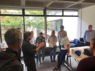 A piece of equipment is being shown to a circle of people