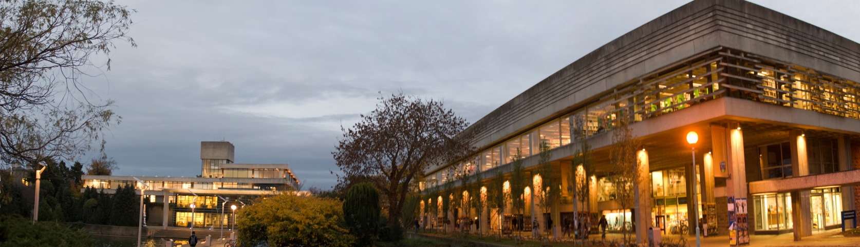 The Tierney building, lit up in warm light on a cloudy evening