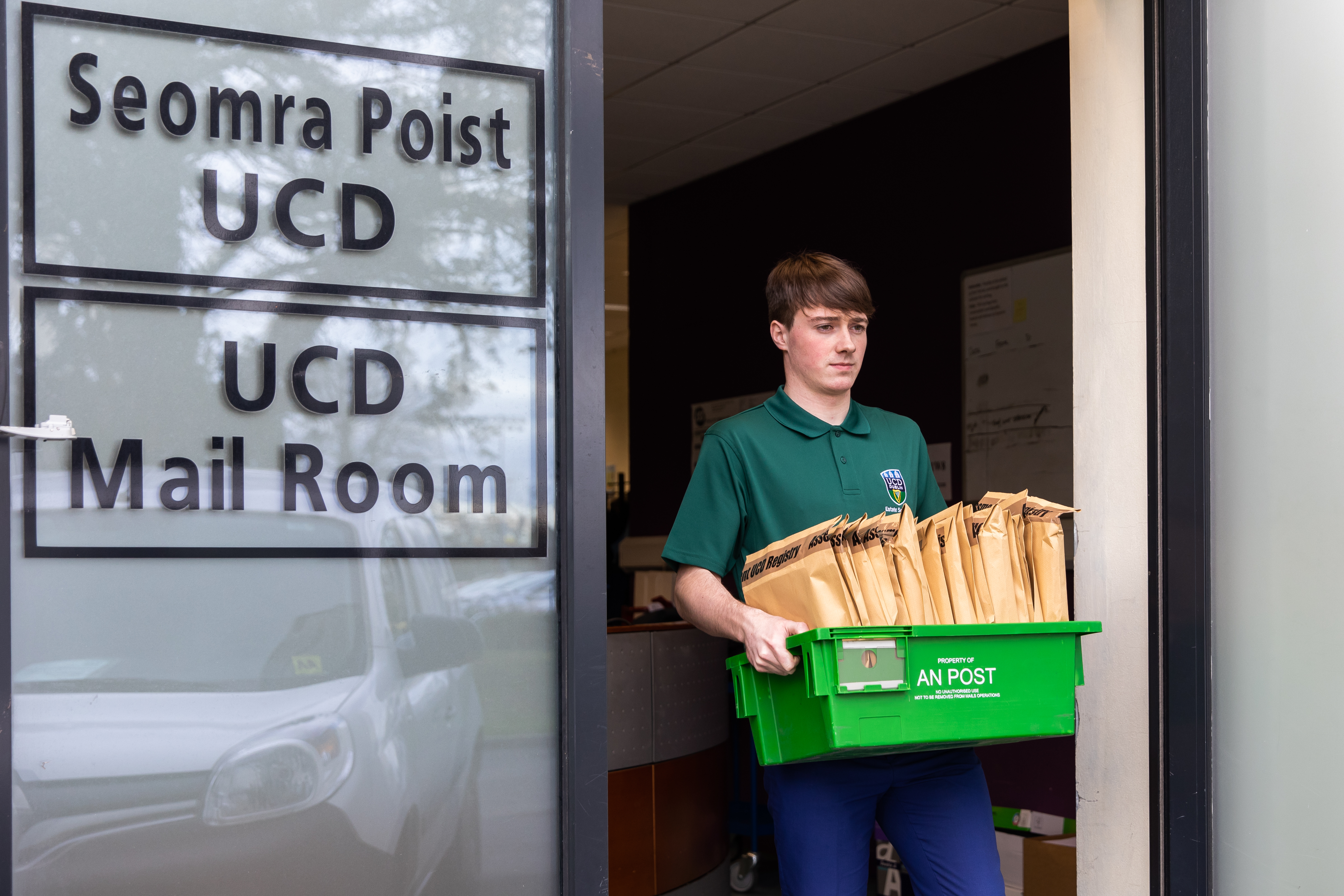 Man carrying box of mail