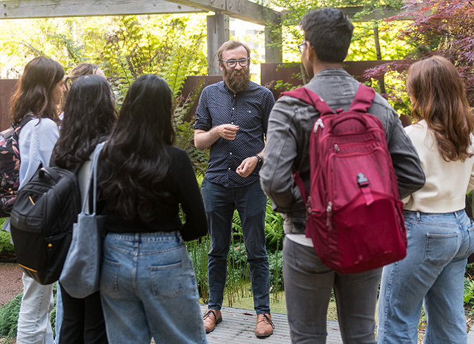 Dr Adam Kane delivering a field class at the Plant Evolution Garden