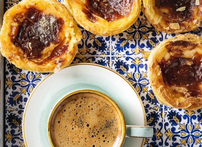 Portuguese pastries and coffee on colourful tiles