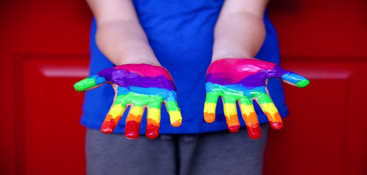 Open rainbow painted hands