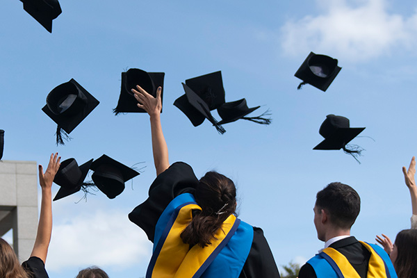 Graduating students throwing their caps in the air