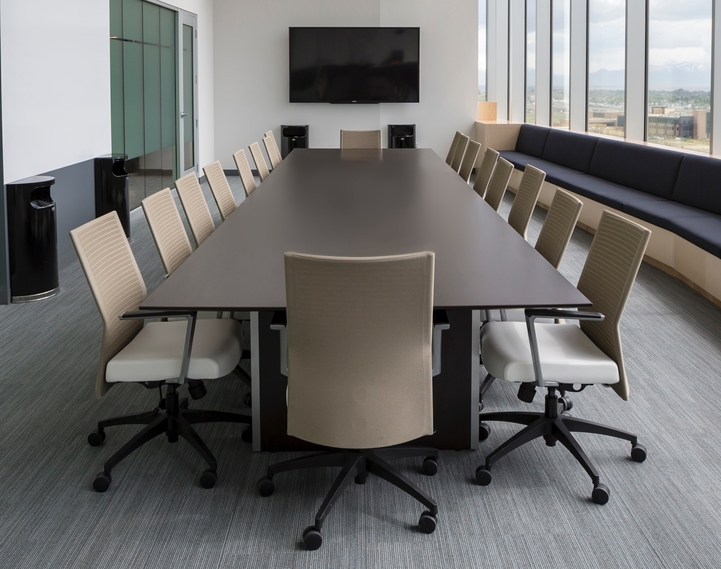 A boardroom with desk and chairs