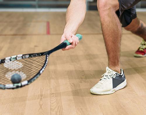 A squash ball on racket