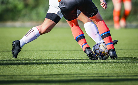 A football player attempting to pass an opponent