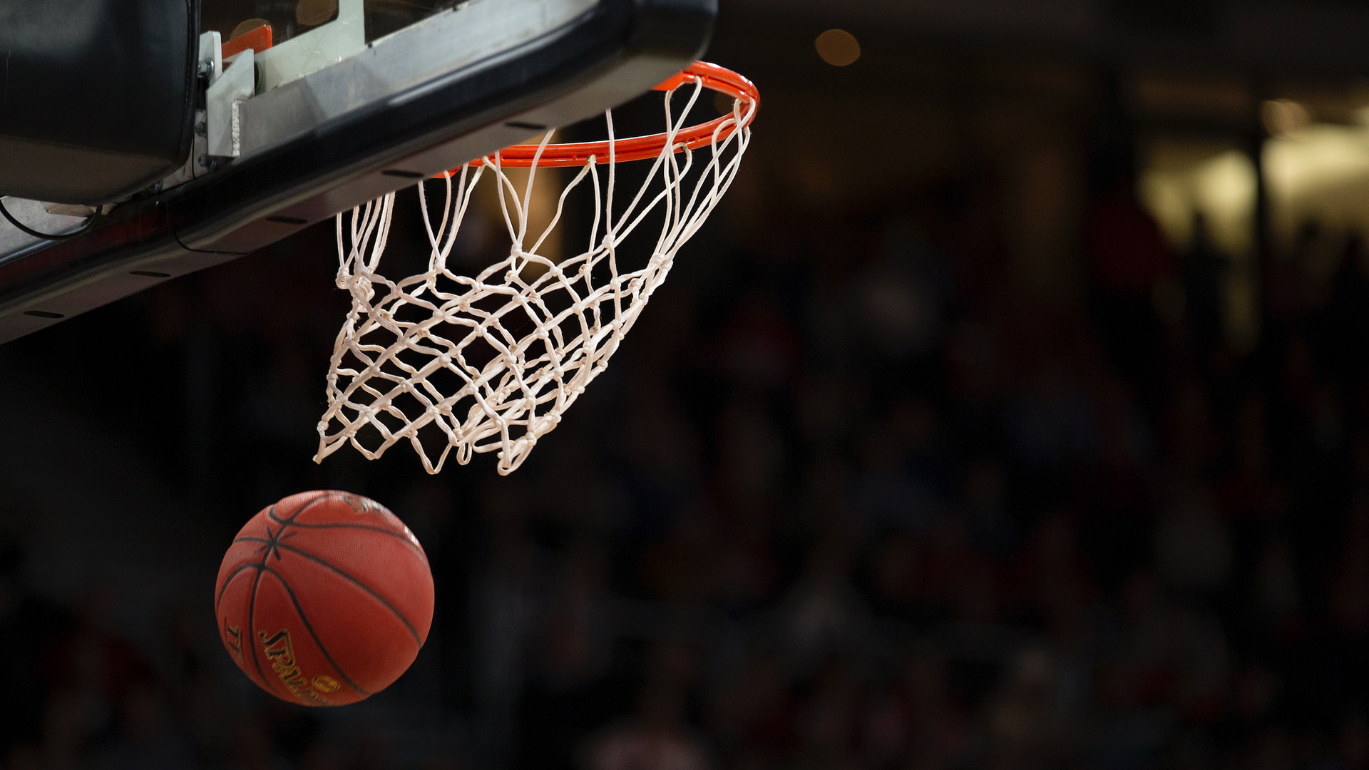 A basketball dropping through a hoop