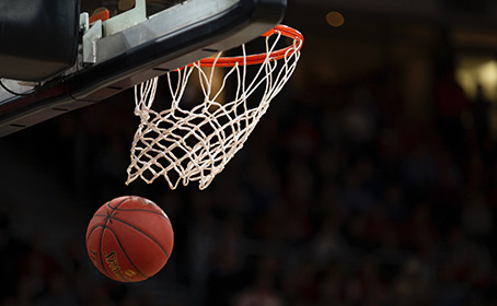 A basketball dropping through a hoop