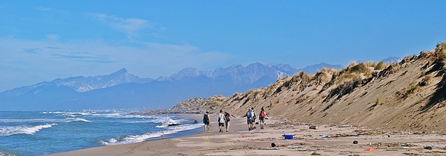 Students taking part in fieldwork on a beach in Tuscany