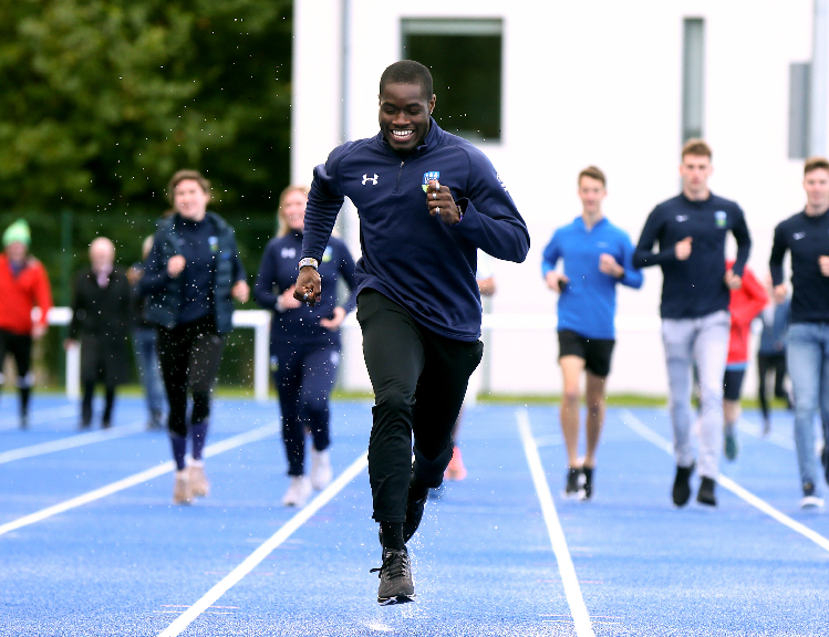 Photo of UCD student Bori Akinola running on the new track