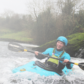 student canoeing on a river