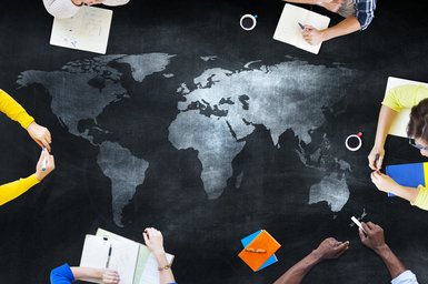 Black map with students studying