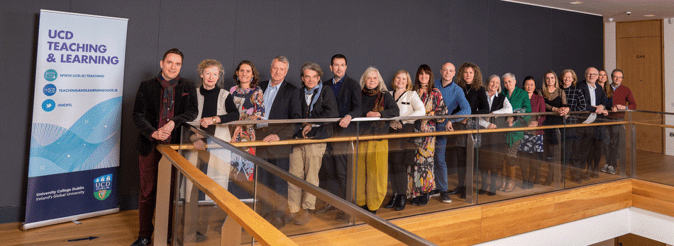 The winners of the 2019-20 UCD University Teaching and Learning Awards, standing in a line along a railing.