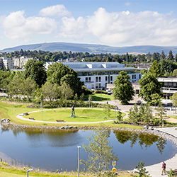 A view across UCD's Upper Lake on the Belfield Campus including (l to R) UCD Sutherland School of Law, Roebuck student residences, UCD Lochlann Quinn School of Business and UCD Gerald Manley Hopkins International Centre.
