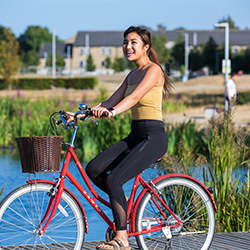 A student cycles past the Upper Lake