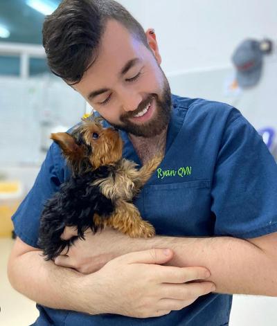 Veterinary nurse Ryan Kavanagh holding a puppy