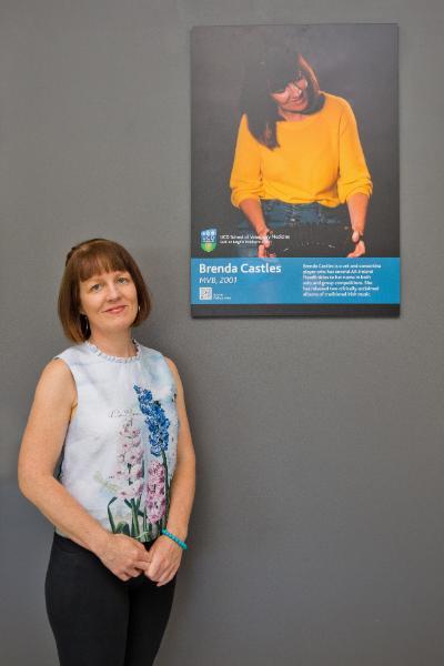 Brenda Castles with her photo on the Alumni Wall