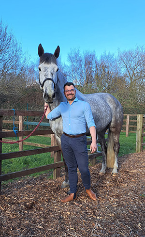 Benoit Cuq from the UCD Vet Hospital standing with Maestro, a grey horse