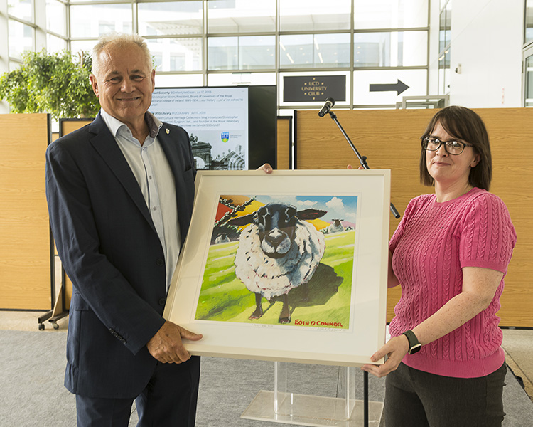 Professor Michael Doherty receives a painting of a sheep from Dr Helen Graham, the Vet School's Communications Manager