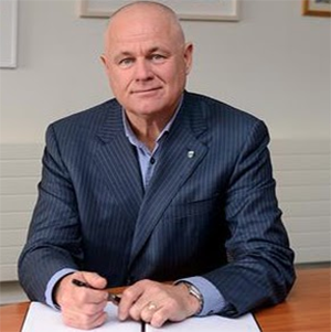 Professor Michael Doherty, Dean & Head of School, sitting at a desk