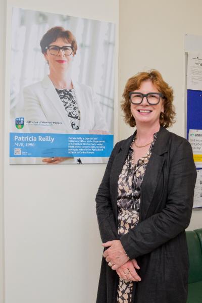 Patricia Reilly with her image on the Alumni Wall