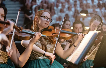 Cara Ryan playing violin with the Cross Border Orchestra of Ireland