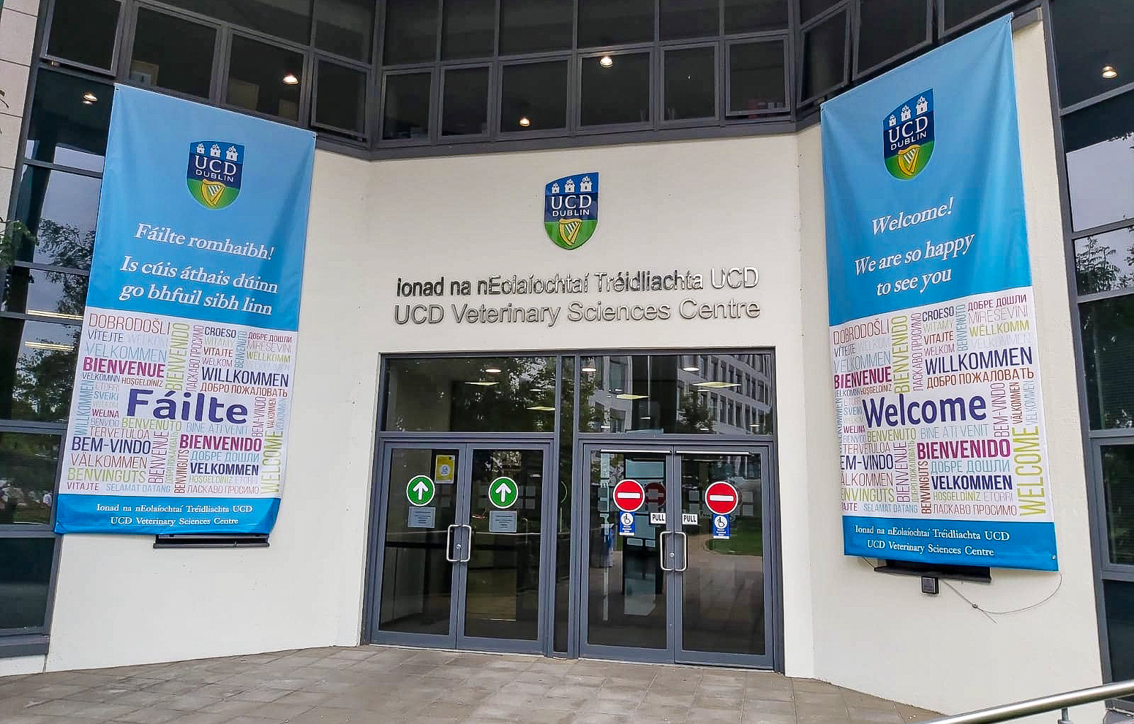 Photo of the front of the UCD Veterinary Sciences Centre with two banners hanging either side of the door with welcome messages on them