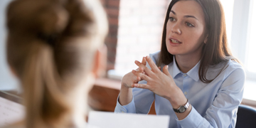 Image of two people talking